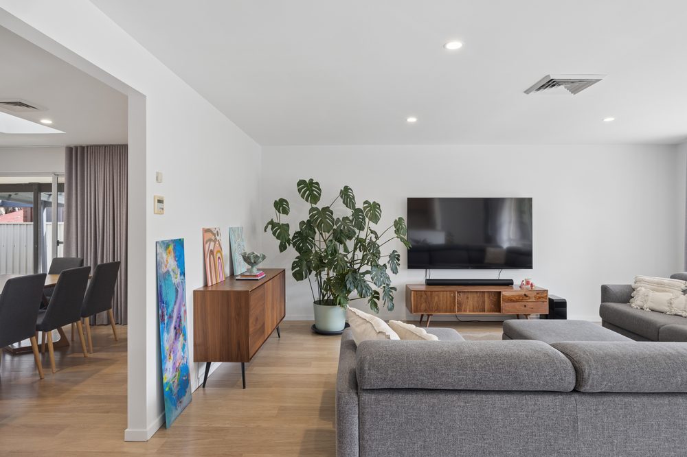 Living room with television and sofa seen from the dining area